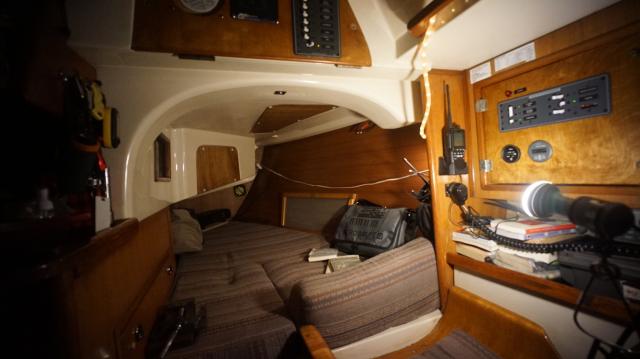 A berth with wood panels bolted left and above.