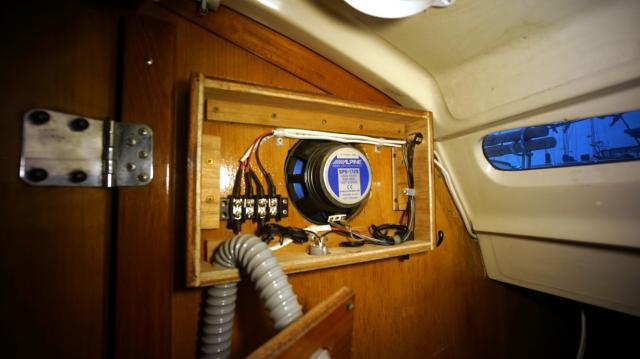 A wooden speaker enclusre with a potted light and a 8 port gang bus.