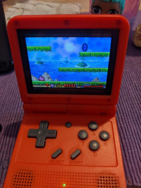 Powkiddy V90 (shaped as a GBA foldable) running retro games 