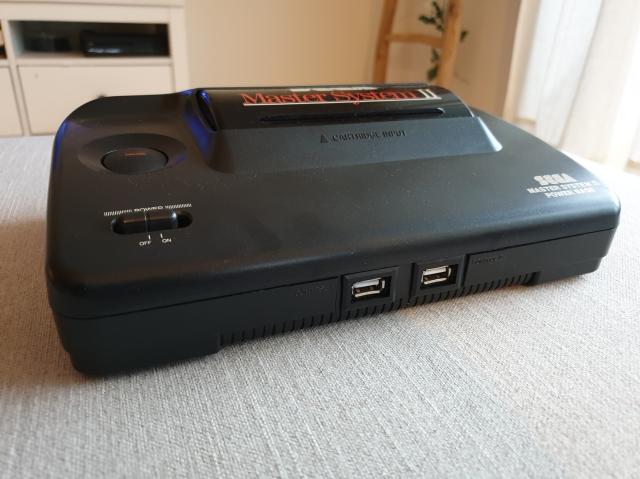 Sega Master System 2 retrofitted with Raspberry Pi. The original controller ports were swapped for USB, and the rear IO Was updated too.