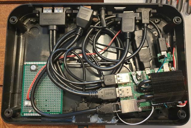 A bird's nest of cables inside the Master System, connecting the Pi ports to extensions mounted to a custom 3D printed backplate.