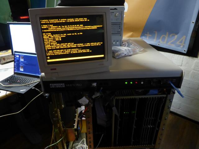 DEC VAX 11/750 with a DEC VT510 on top showing a NetBSD console including the output of "dmesg | head" and "ping6"
