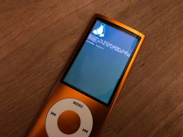 An iPod Nano 5g showing a linux boot prompt, including penguin, but the colors are wrong.