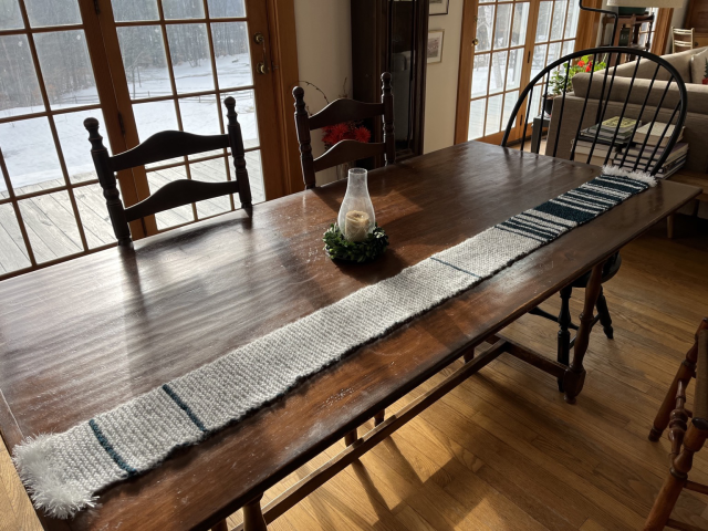 Blue and white scarf on a dining table, gradations from white to blue