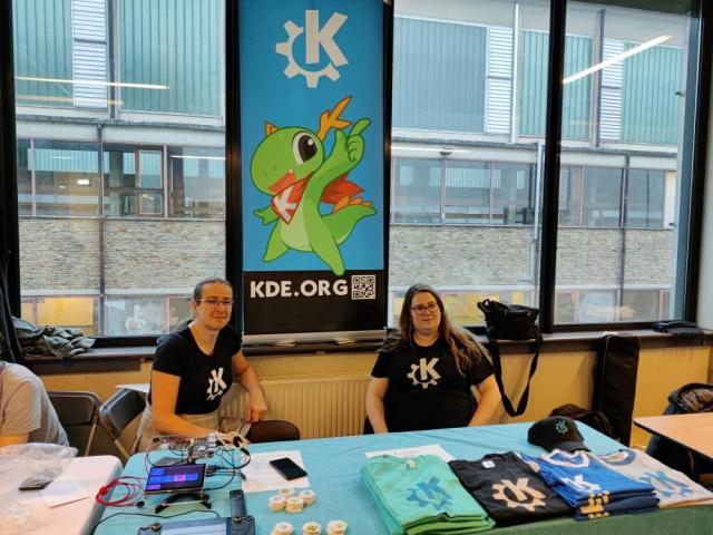KDE community members staffing the booth at FOSDEM.