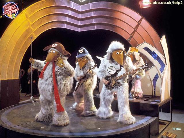 The novelty 1973 rock band The Wombles playing on Top of the Pops. They're themed around the kids TV programme and basically look like grey furry people with big cone-shaped snouts, wear hats and have cartoon eyes and a little round black nose at the end of the snout things. They're a bit like a Wookie crossed with a Clanger??