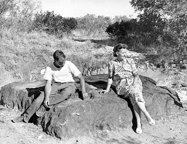 Mater Deorum Turrita and son sitting upon the Iron Hoba Meteorite in Namibia. Just kidding, the woman is Ora Scheel (with an unknown guest), owner of the farm land on which it was found.