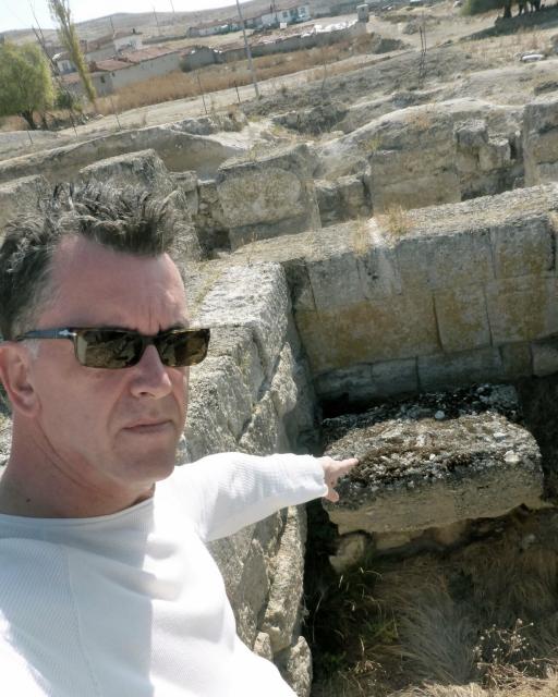"Andrew Gough in 2013 at the ruins of Pessinus in Turkey, pointing to the altar where the incarnation of the goddess, Cybele (a meteorite that was later acquired and moved to Rome), was worshipped."

https://andrewgough.co.uk/photography/