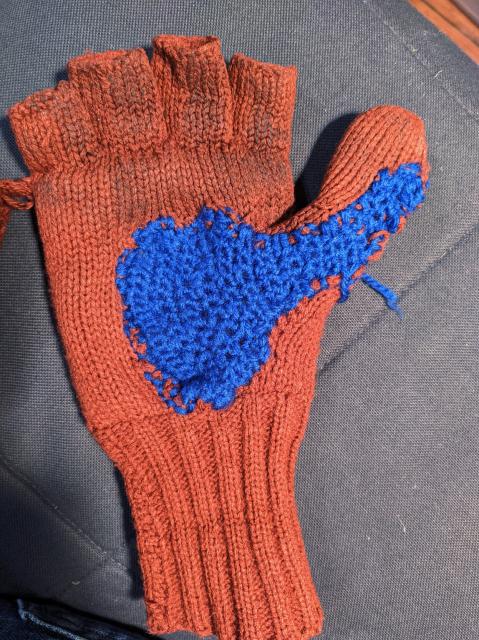 The Red brown glove with a quick and dirty bright blue crochet repair.