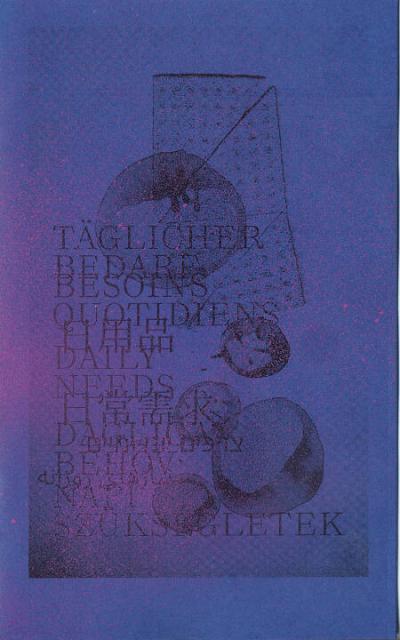 the blue cover is sprinkled with pink spray paint and shows some melting forms and the title in different languages “Täglicher Bedarf, Besoins Quotidiens, Daily Needs, etc.”