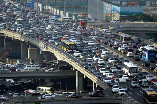 Heavy traffic going both ways on a highway overpass in a Chinese city. 