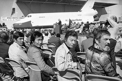 The cast of Star Trek TOS on the tarmac next to the shuttle Enterprise