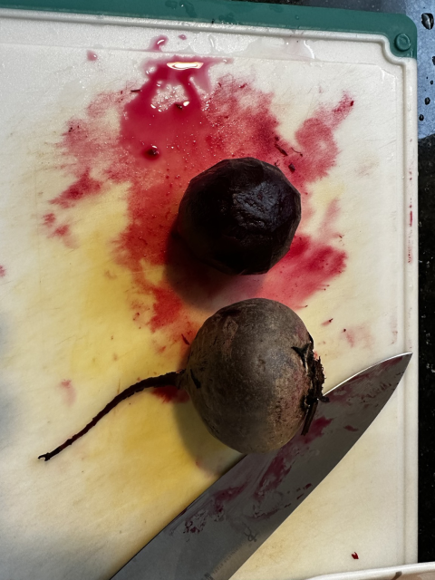 Two boiled beets, one peeled, one not peeled