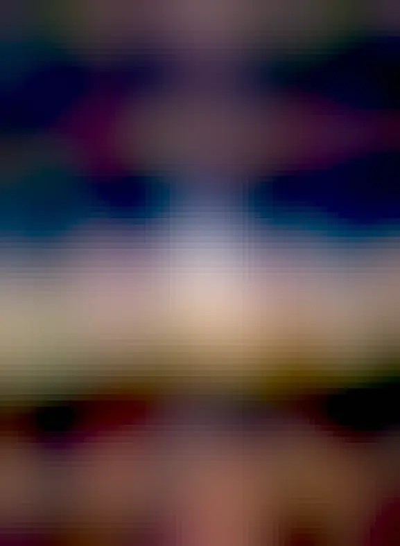 A person is seen sitting on a rock under an unusual sky. In the sky above is light diffuse band extending down to the horizon that goes through two bright dots, Jupiter and Venus. The Pleiades star cluster is visible above them.