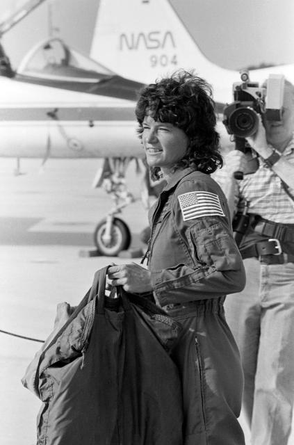 Mission specialist Sally Ride, the first American woman sent into space, totes her own luggage following her arrival at the Kennedy Space Center. Credit: Bettmann
