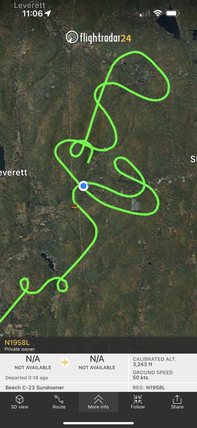 Flight paths on a satellite map showing a forested area with my house represented by a blue dot. That blue dot is right under the loops the plane is making.