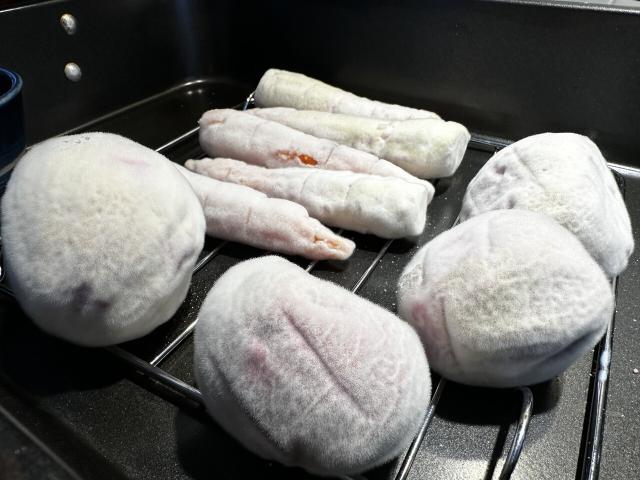 Koji mold grown on carrots and beets. The mold looks like a white fuzzy covering over the vegetables