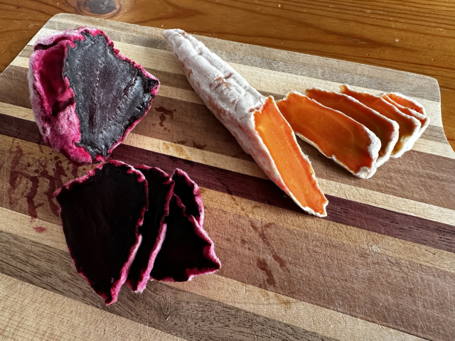 Sliced koji beets and carrots on a cutting board