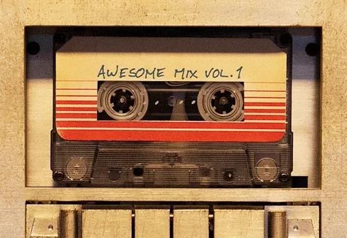 An old cassette tape playing in a tape deck. It is labeled in pen with the words “awesome mix volume 1”. It is a scene from the film Guardians of the Galaxy.